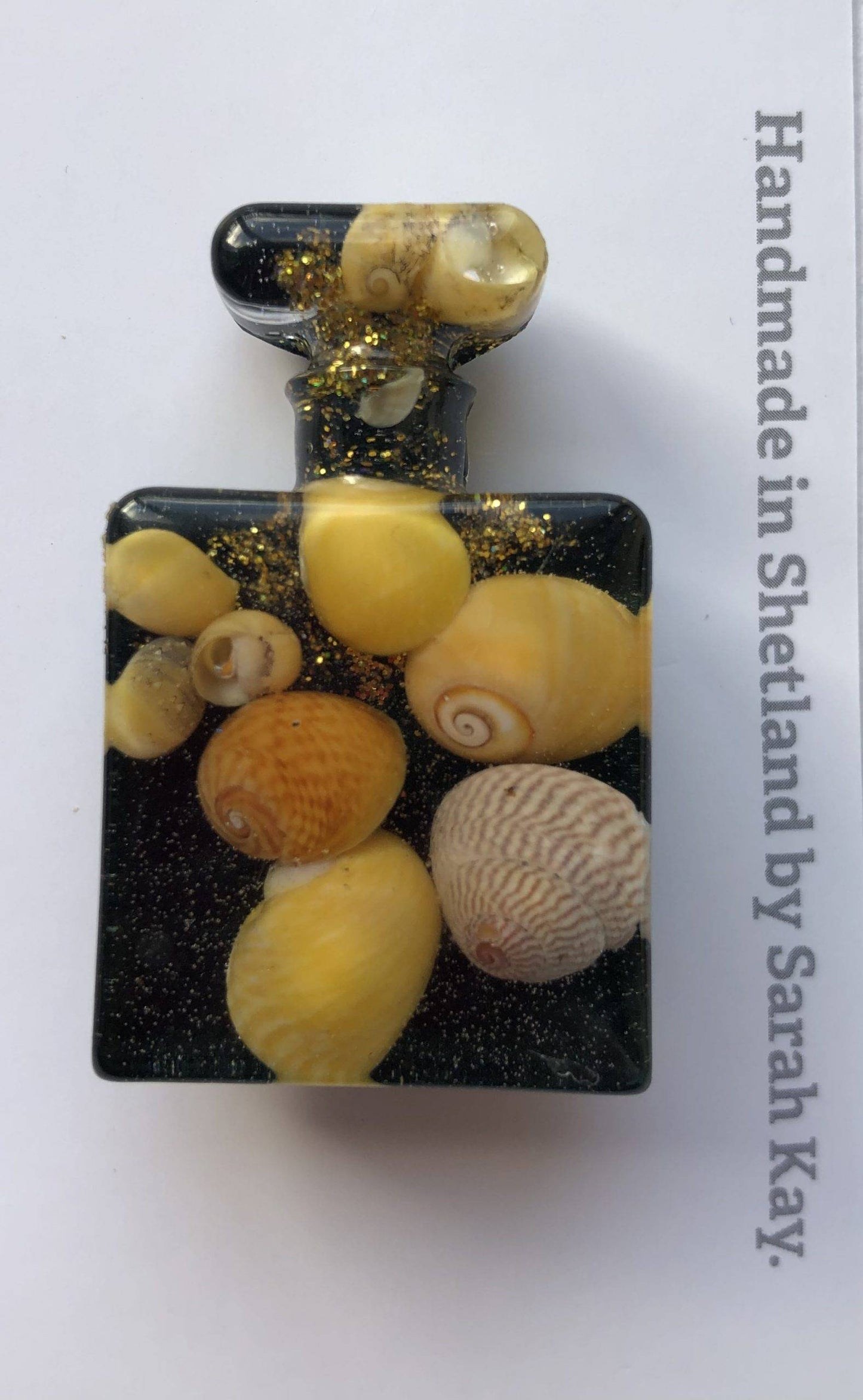 yellow shell brooch