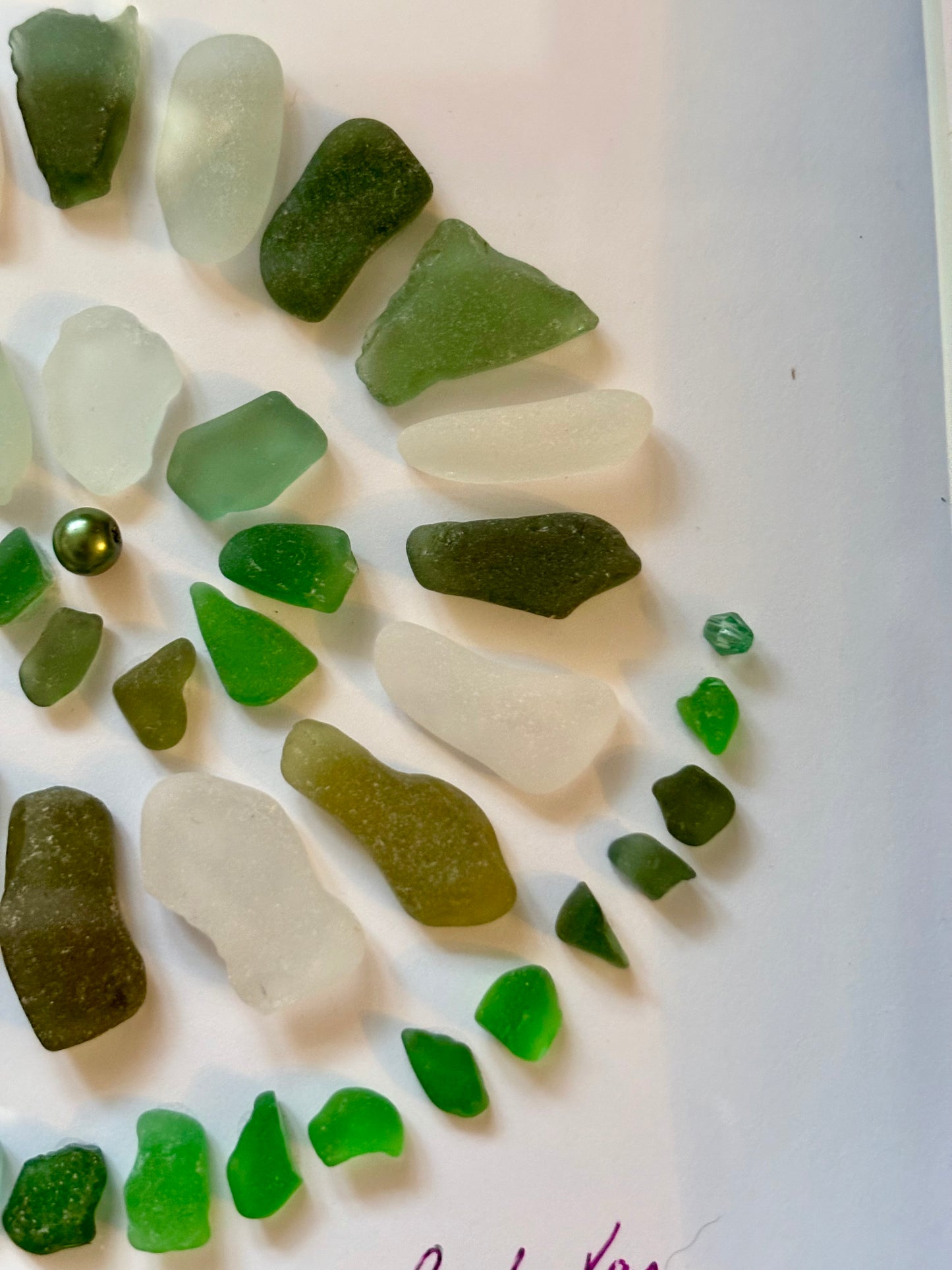Green sea glass spiral art.