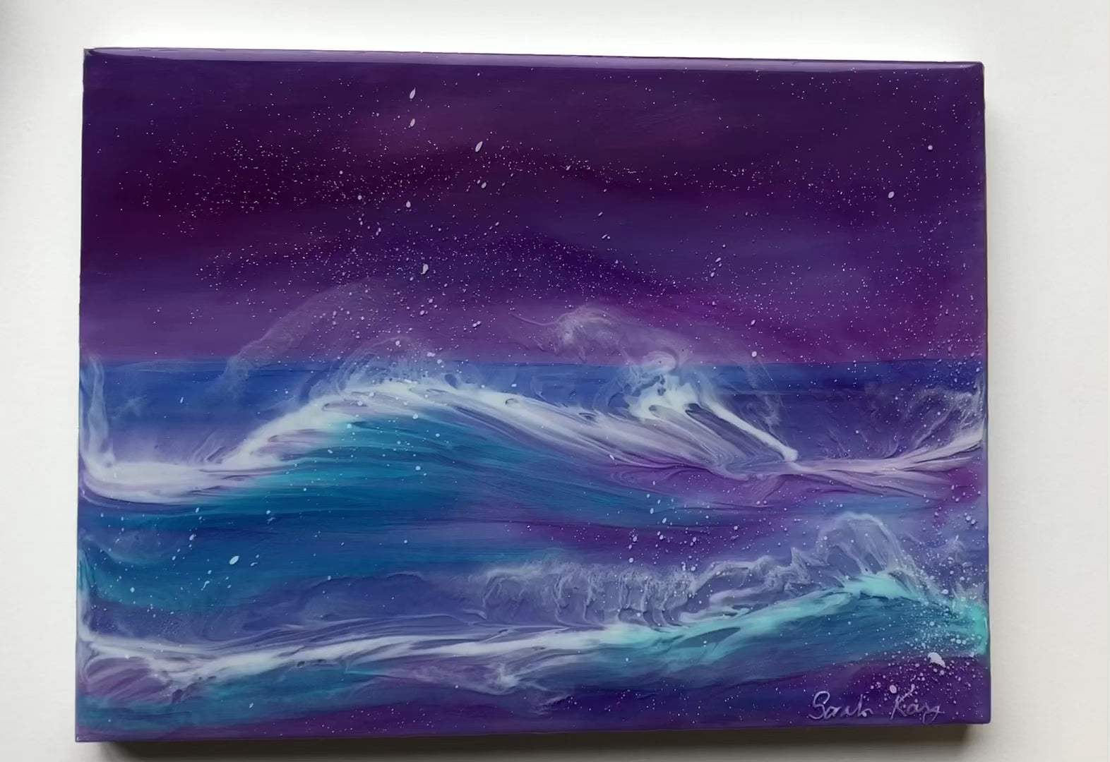 close up of purple seascape painting.